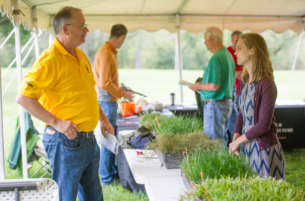 Students in a field with professor